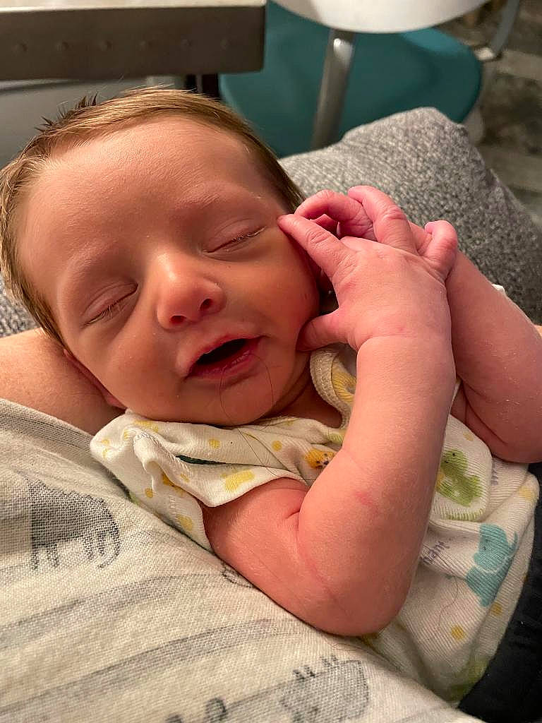 Tracey is registered to the contest to win money with this photo: baby, baby_toddler_clothing, bedtime, cheek, child, comfort, finger, gesture, happy, linens, lip, mouth, nose, person, room, skin, sleep, smile, thumb, toddler