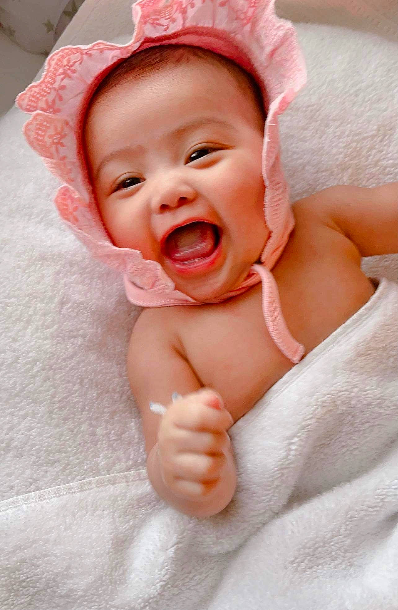 Angela is registered to the contest to win money with this photo: baby, baby_laughing, baby_toddler_clothing, cheek, chin, comfort, eyebrow, face, finger, gesture, happy, headgear, lip, mouth, nose, person, pink, skin, smile, thumb