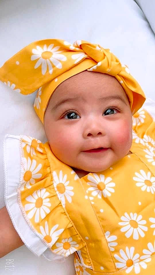 Angela is registered to the contest to win money with this photo: baby, baby_toddler_clothing, cheek, child, chin, eyebrow, face, fun, happy, headwear, iris, linens, lip, orange, peach, person, pink, skin, sleeve, smile