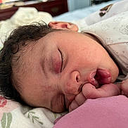 Eliana Izia joined the competition — help win amazing prizes! baby, sleeping, close_up, face, hand, curly_hair, blanket, pattern, floral, infant, peaceful, resting, cute, newborn, pink, skin, mouth, finger, soft_lighting, indoors