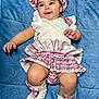 Isabella joined the competition — help win amazing prizes! baby, infant, child, smiling, pink_clothing, bonnet, socks, blanket, blue_background, happy, cute, chubby_legs, lying_down, portrait, indoors, soft_texture, playful, warm_clothing, adorable, person