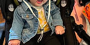 Isabella joined the competition — help win amazing prizes! toddler, child, hat, denim_jacket, car_seat, white_shoes, black_pants, indoor, cute, smiling, baby, footwear, clothing, seat, person, young_child, headwear, casual_wear, comfortable, curious