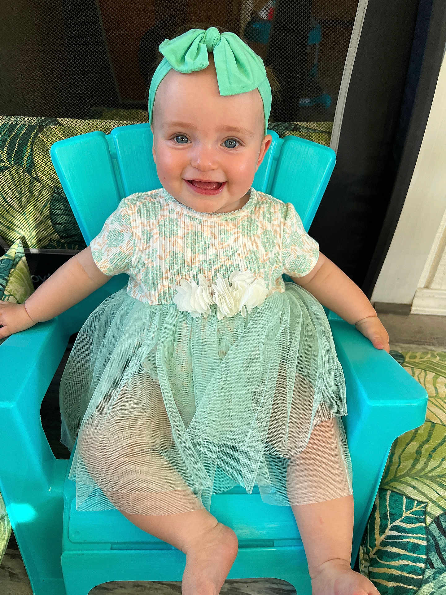 Raina is registered to the contest to win money with this photo: baby, child, smiling, dress, headband, chair, blue, tulle, happy, portrait, indoor, cute, infant, toddler, person, sitting, clothing, face, skin, fashion