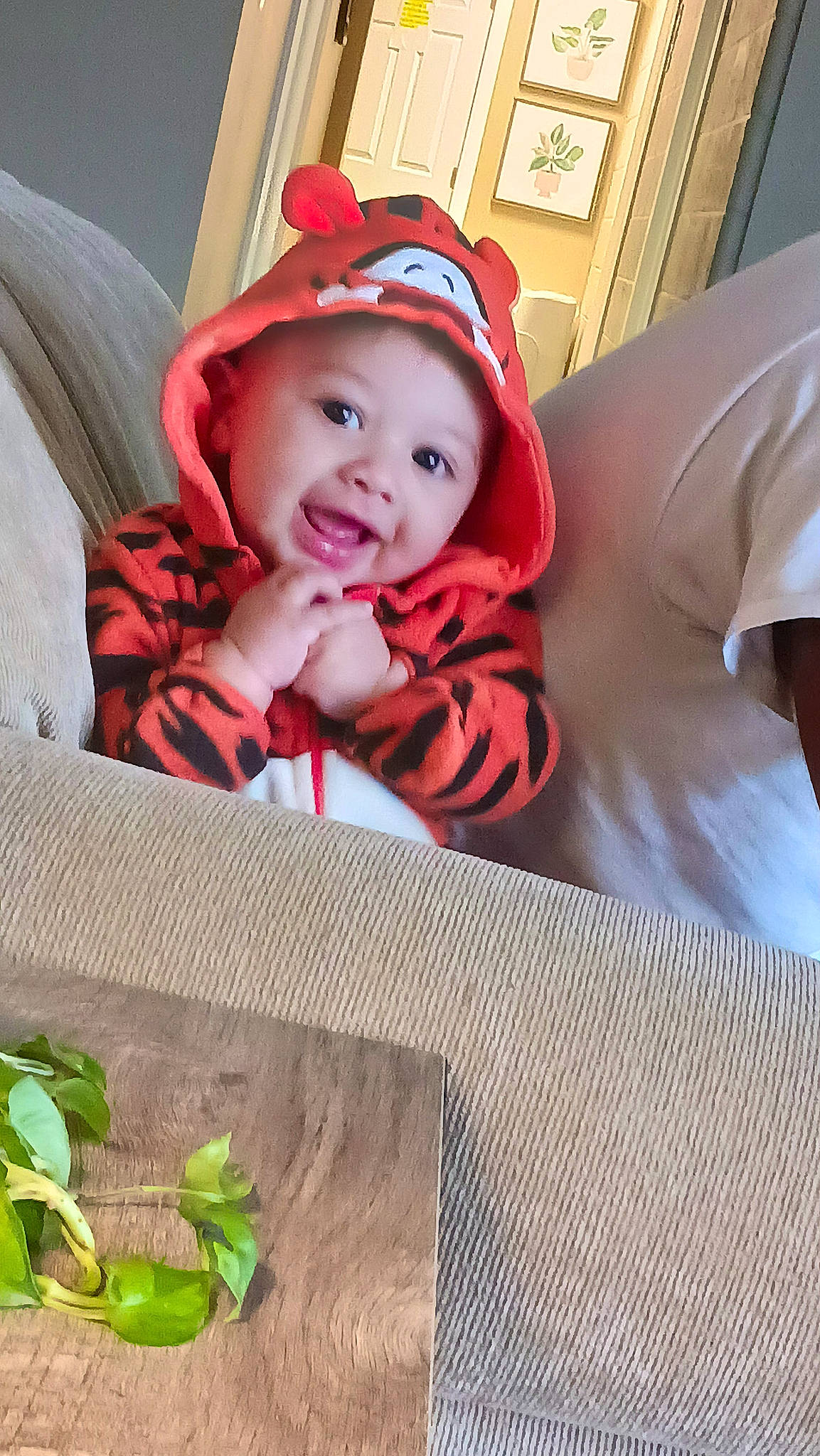 Adonis is registered to the contest to win money with this photo: baby, baby_laughing, baby_products, baby_toddler_clothing, child, comfort, face, flooring, grass, happy, headwear, linens, person, petal, plant, selfie, sitting, smile, t_shirt, textile