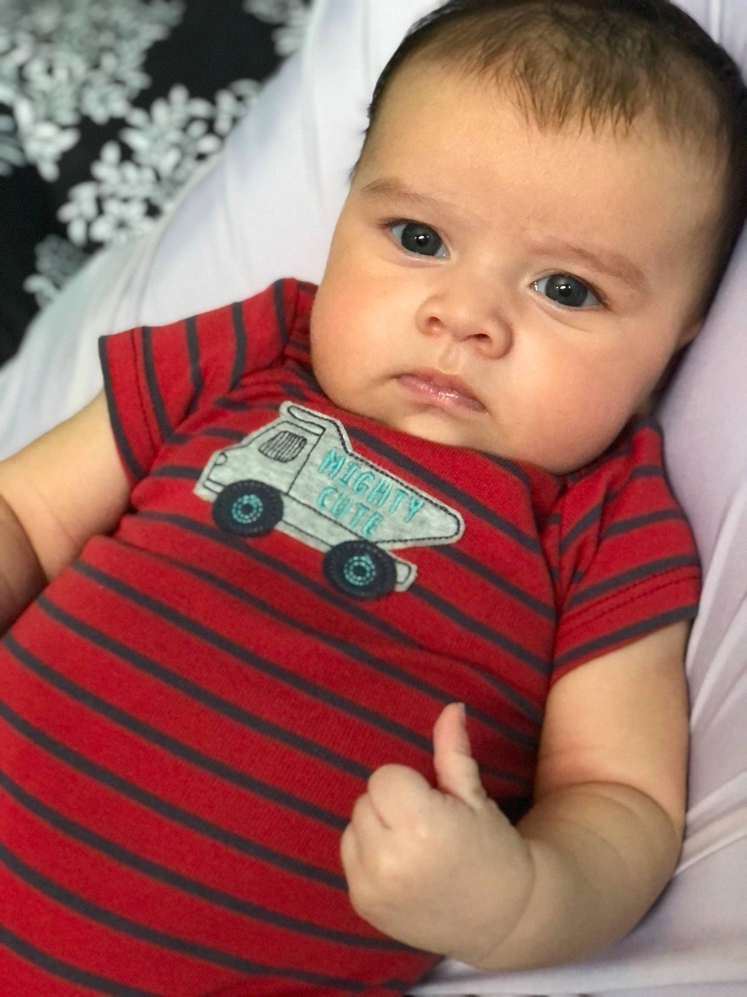 Mylo is registered to the contest to win money with this photo: arm, baby, baby_toddler_clothing, cheek, eyelash, finger, hand, happy, human_body, iris, lip, neck, nose, pattern, person, product, skin, sleeve, t_shirt, textile