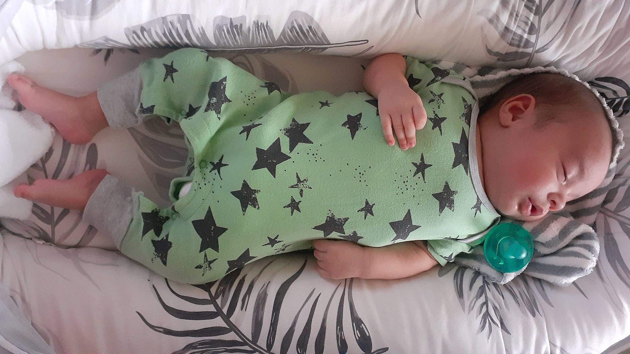 Elias is registered to the contest to win money with this photo: baby, baby_sleeping, baby_toddler_clothing, comfort, eye, face, finger, gesture, hand, hat, head, headgear, human_body, joint, mouth, neck, person, skin, sleeve, textile