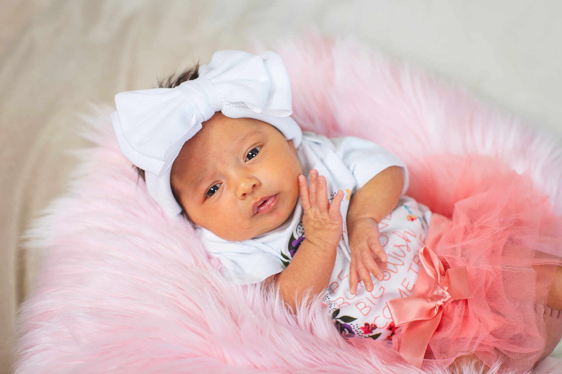 Kayelani joined the competition — help win amazing prizes! baby, infant, headband, bow, tutu, pink, fluffy, blanket, clothing, cute, portrait, newborn, child, soft, hands, face, lying, expression, adorable, closeup