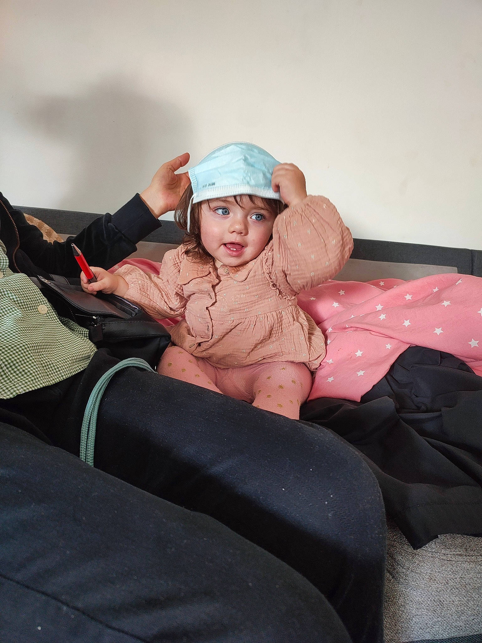 Arya participe au concours pour gagner de l'argent avec cette photo : baby, bedding, cap, comfort, fashion_accessory, flash_photography, flooring, fur, headwear, human_leg, knee, linens, magenta, person, room, sitting, sleeve, sock, t_shirt, textile