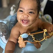 Micah is registered to the contest to win money with this photo: baby, child, smiling, happy, walker, toy, indoor, infant, cute, portrait, face, hand, playful, young, baby_toys, expression, closeup, person, cheerful, bright