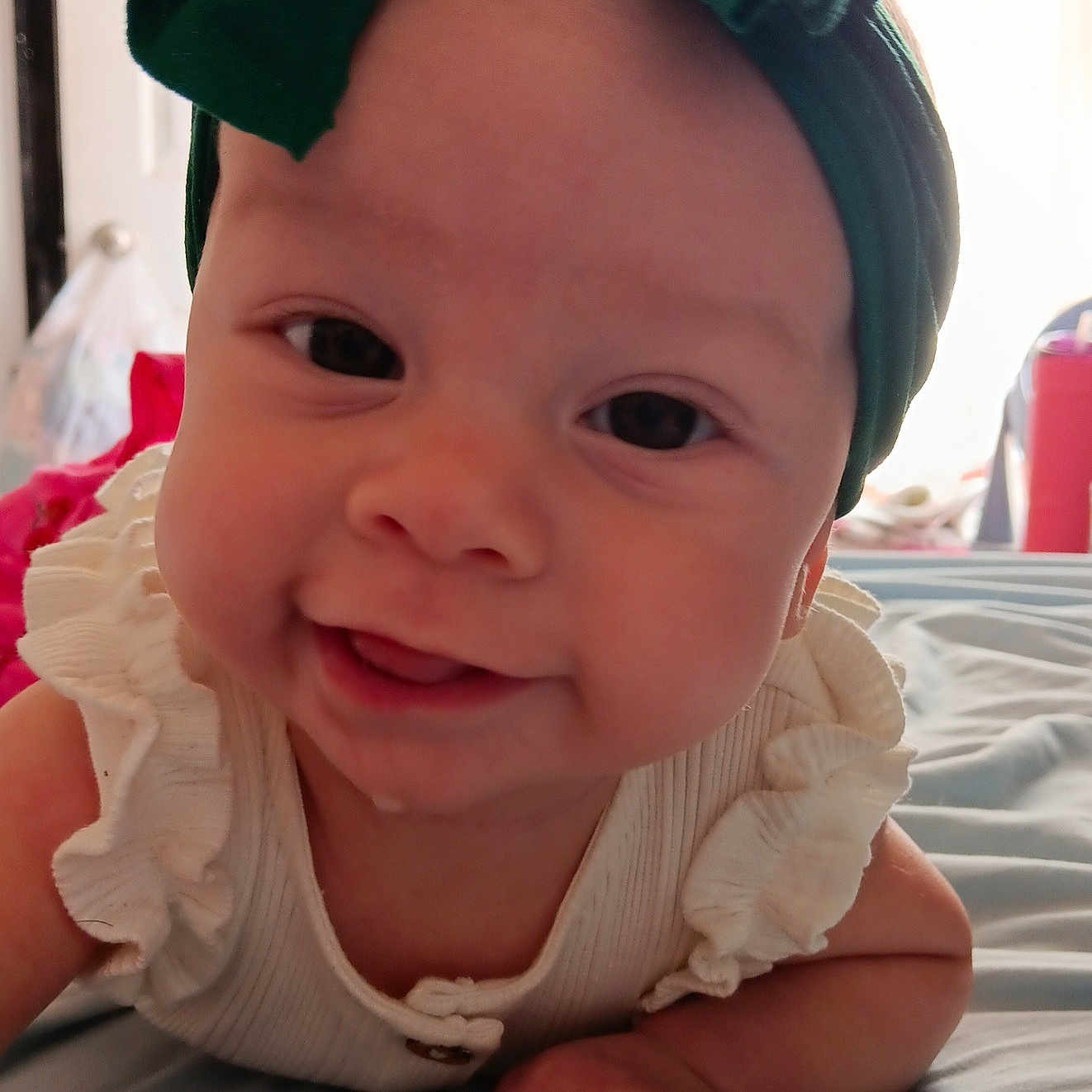 Phoenix is registered to the contest to win money with this photo: accessories, baby, bodypart, bonnet, cap, clothing, dress, face, finger, hand, happy, hat, head, headband, newborn, person, photography, portrait, smile, turban