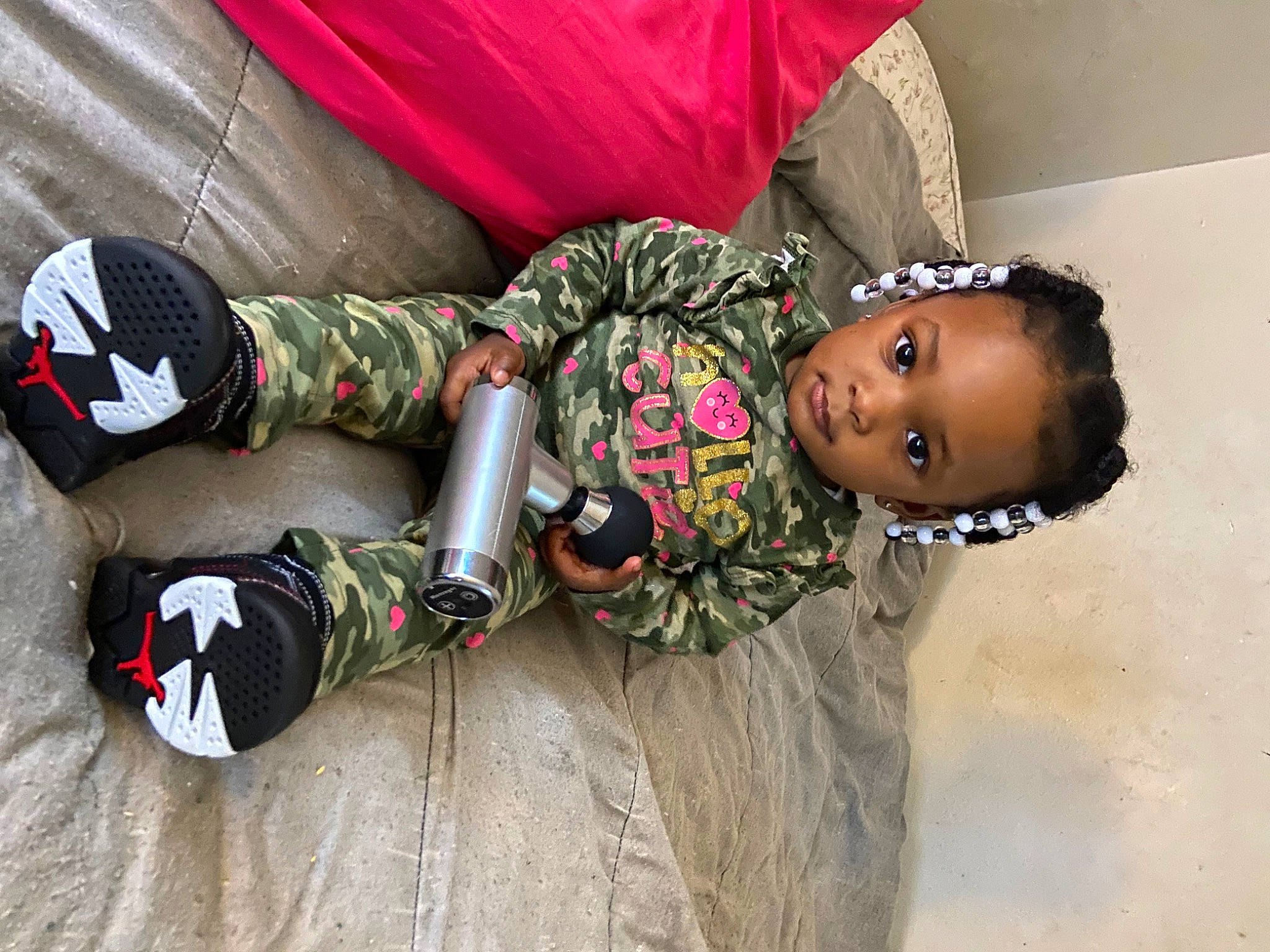 Ava is registered to the contest to win money with this photo: abdomen, adventure, baby, carmine, child, costume, fashion_accessory, fun, happy, jewellery, pattern, people, person, personal_protective_equipment, sitting, toddler, tradition, tree, trunk, wood