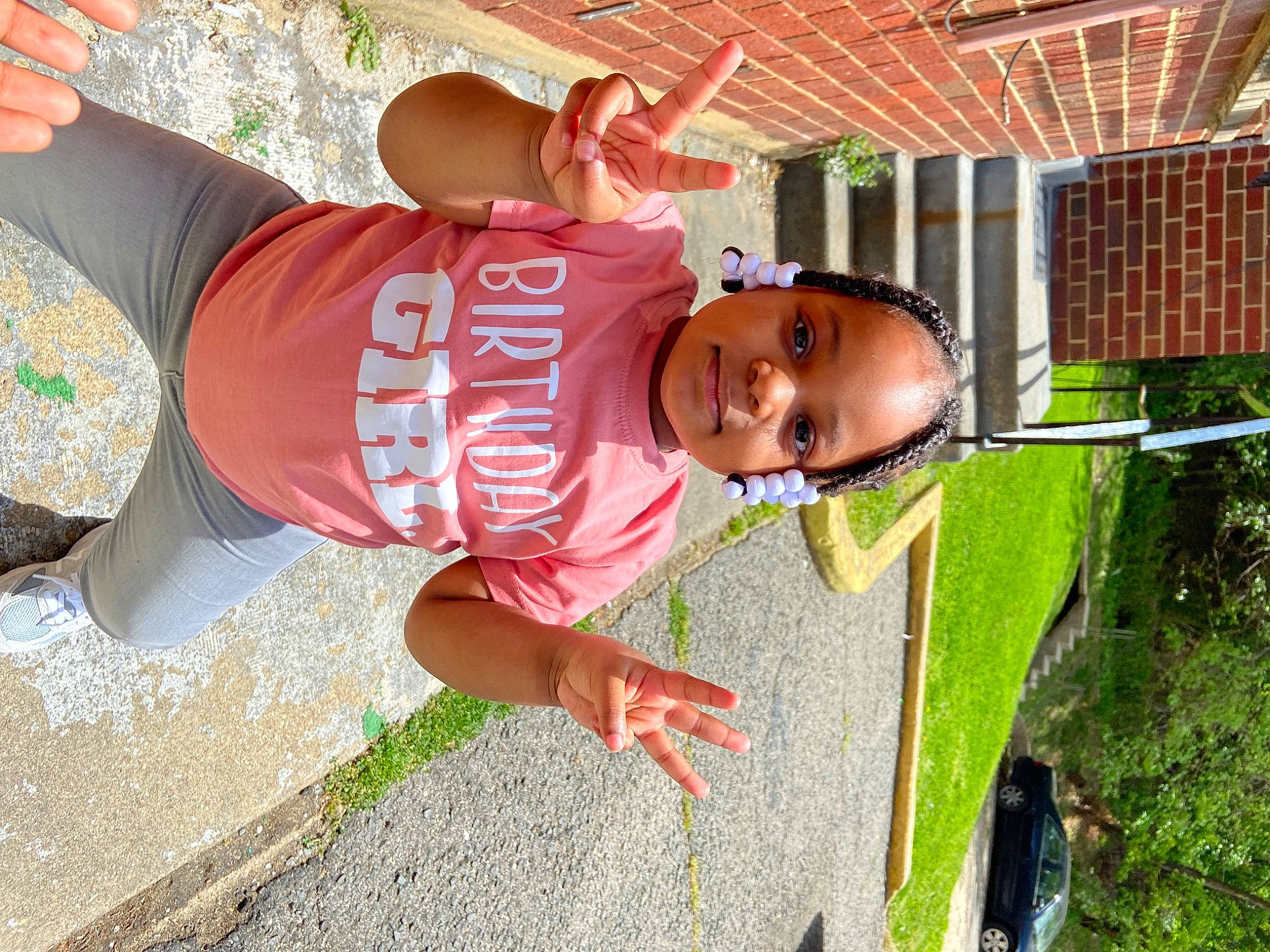 Taylor is registered to the contest to win money with this photo: child, fun, grass, green, happy, hat, landscape, leisure, mouth, person, pink, plant, play, recreation, soil, spring, sun_hat, t_shirt, toddler, tree