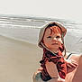 toddler, child, hat, beach, water, waves, adult, holding, sunhat, summer, outdoor, ocean, person, clothing, tattoo, skin, hand, portrait, casual, nature