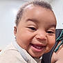 Reina joined the competition — help win amazing prizes! baby, smiling, close_up, face, person, child, infant, happy, teeth, clothing, indoor, skin, head, hair, holding, shoulder, adult, joy, cute, expression