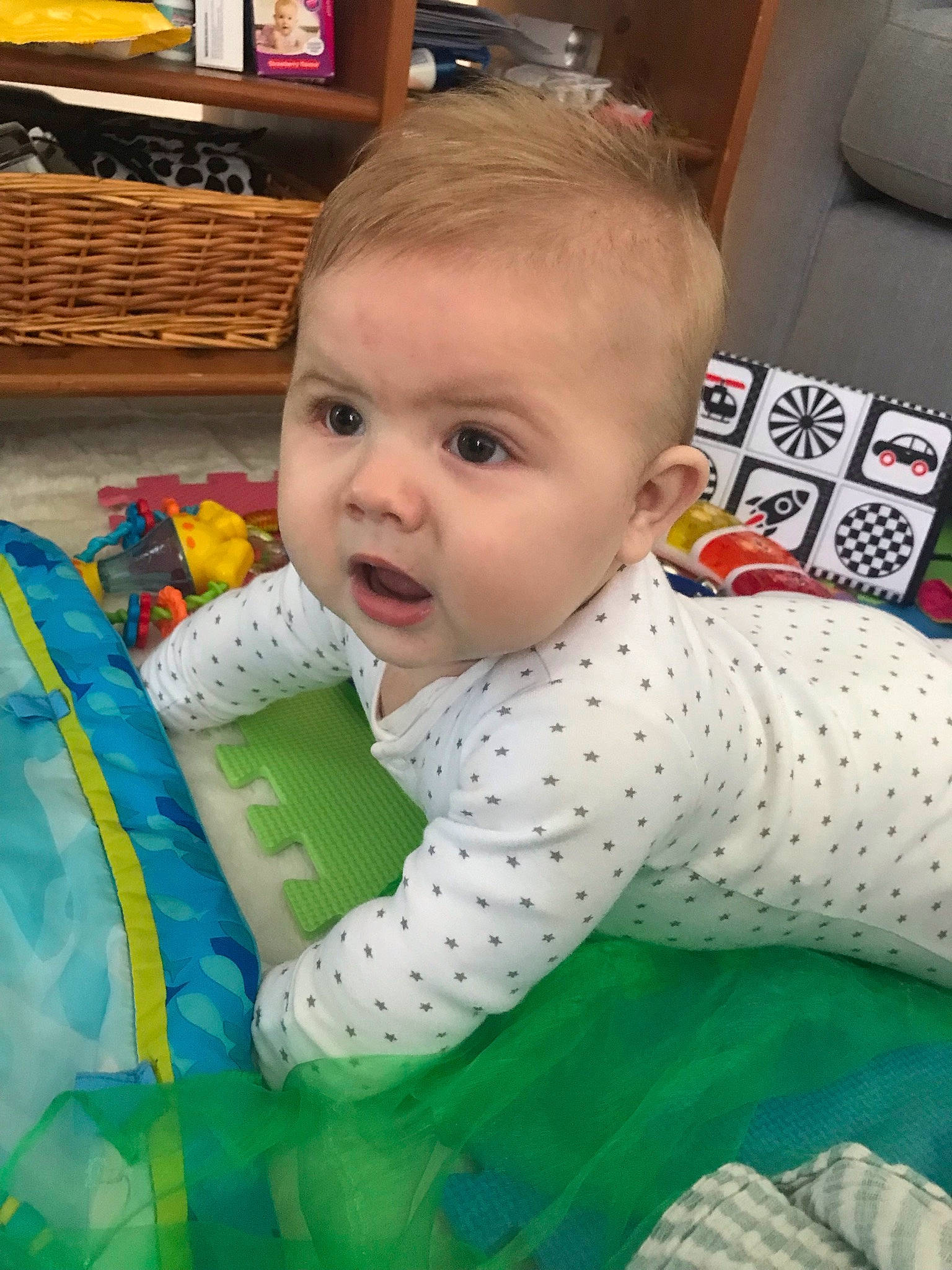 Frankie is registered to the contest to win money with this photo: baby, baby_products, baby_toddler_clothing, cheek, child, face, flooring, fun, happy, head, iris, linens, pattern, person, play, room, shelf, sitting, sleeve, smile