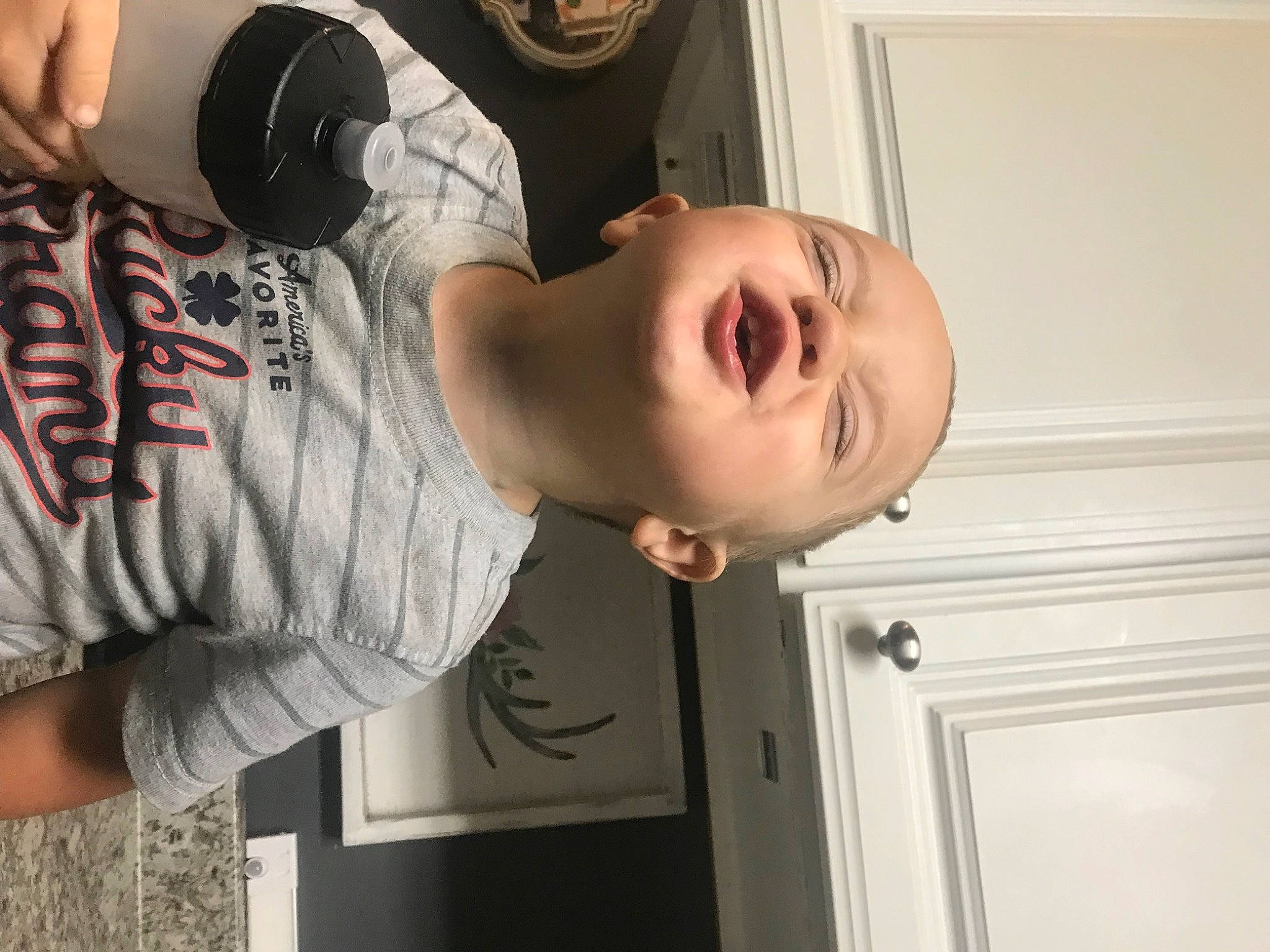 Jaxson is registered to the contest to win money with this photo: baby, baby_products, baby_toddler_clothing, child, elbow, eyewear, finger, gesture, happy, human_leg, mouth, neck, person, room, shoulder, sitting, sleeve, smile, t_shirt, thigh
