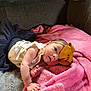 baby, infant, bow, headband, pink_blanket, couch, soft_texture, clothing, cute, child, face, portrait, indoor, cozy, resting, curious, small_hands, toddler, blanket, sitting