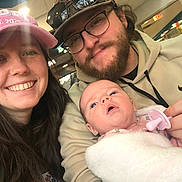 Lillyanna Marie joined the competition — help win amazing prizes! baby, newborn, adult, selfie, family, smiling, hat, cap, glasses, sunglasses, beard, pacifier, blanket, hoodie, indoor, ceiling_lights, portrait, casual, hands, cozy