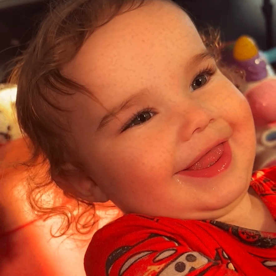 Maliyah joined the competition — help win amazing prizes! candid, cars_theme, child, closeup, colorful, curly_hair, cute, expression, face, freckles, happy, indoor, playful, portrait, red_shirt, smile, sunlight, toddler, toy, warm_light