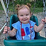 toddler, child, swing, playground, outdoor, smile, pigtails, blue_shirt, necklace, chains, green_swing, grass, trees, sunlight, happy, face, hands, summer, casual_clothing, park