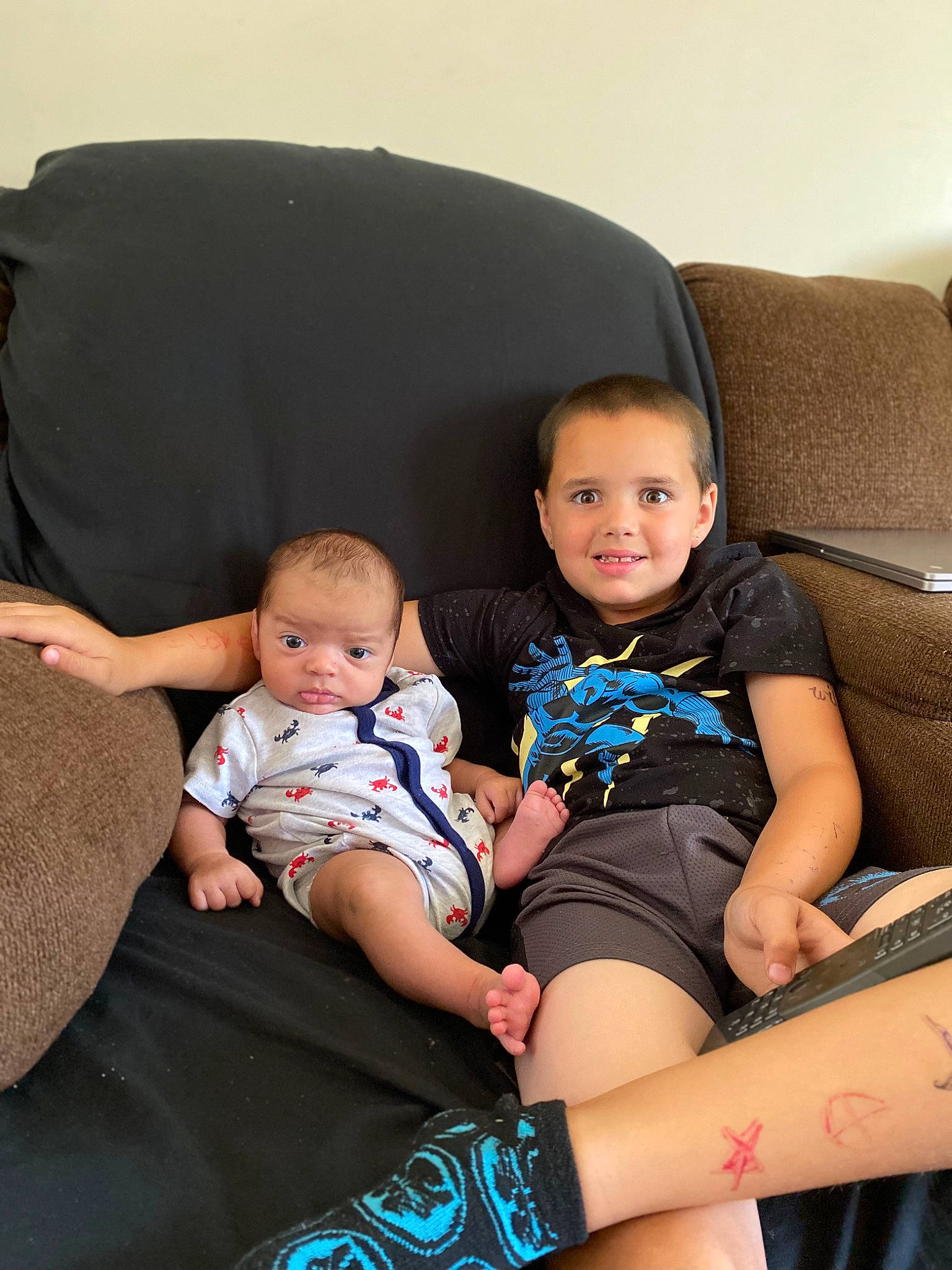 Jeffrey is registered to the contest to win money with this photo: baby, comfort, couch, finger, fun, hairstyle, happy, human_body, human_leg, joy, knee, lap, leg, people, person, shorts, shoulder, skin, t_shirt, thigh