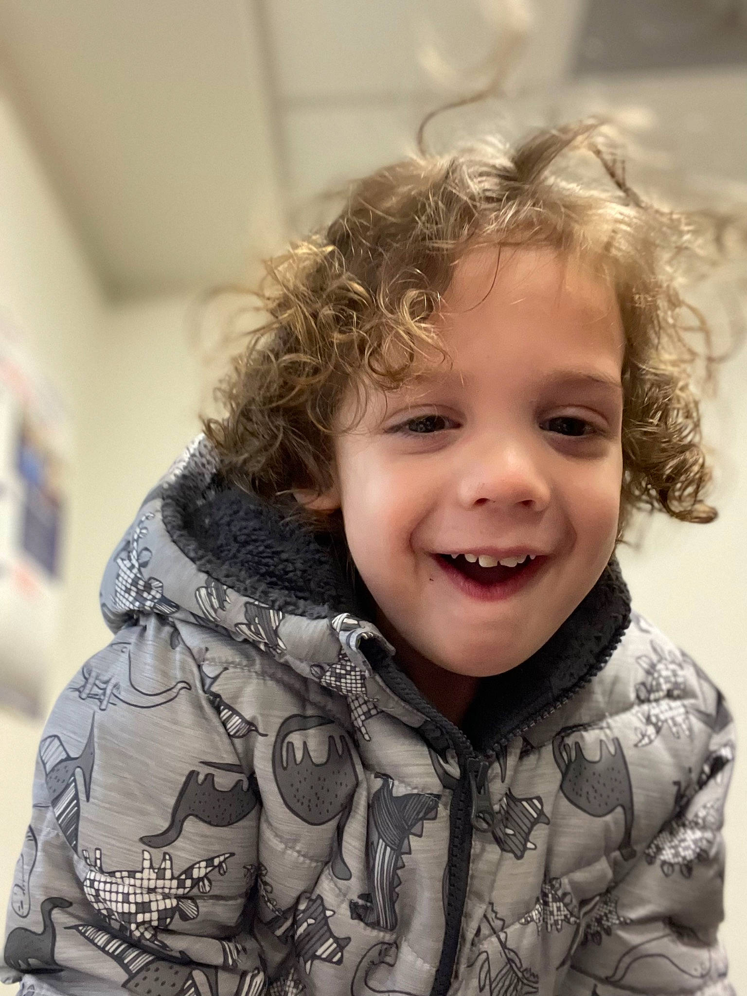 Jayce is registered to the contest to win money with this photo: cheek, child, facial_expression, flash_photography, fun, fur, gesture, hair, happy, human_body, iris, joy, laugh, lip, nose, outerwear, pattern, person, sitting, sleeve