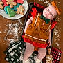 baby, infant, child, gingerbread_outfit, bow, smile, cookies, holiday_cookies, christmas_cookies, baking_tray, rolling_pin, flour, table, kitchen_towels, festive, red, green, white, cute, holiday