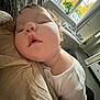 Tayler is registered to the contest to win money with this photo: baby, sleeping, couch, indoor, child, face, resting, white_clothing, window, pillow, living_room, comfort, peaceful, infant, relaxed, soft_light, home, nap, young_child, texture
