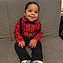 Josiah is registered to the contest to win money with this photo: toddler, child, smiling, plaid_shirt, suspenders, black_pants, gray_couch, socks, indoors, cute, portrait, happy, young_child, hair, person, seated, casual_clothing, small_hands, cozy, baby