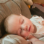 Lyla joined the competition — help win amazing prizes! baby, sleeping, couch, infant, onesie, face, peaceful, child, home, rest, skin, eyelashes, soft, cozy, closeup, person, indoor, cute, relaxing, comfort