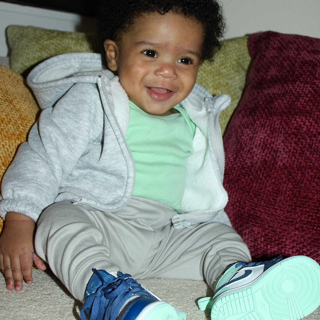 Michael joined the competition — help win amazing prizes! baby, bodypart, clothing, couch, face, finger, footwear, furniture, hand, head, knitwear, pants, person, photography, portrait, runningshoe, shoe, sitting, sneaker, sweater