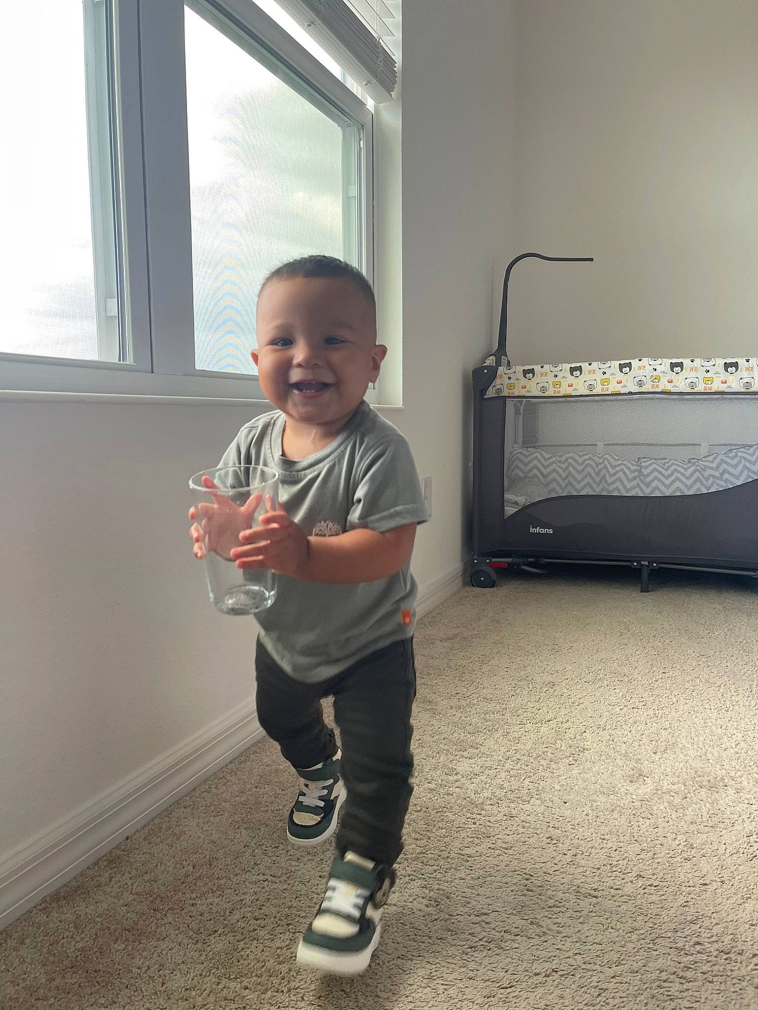 Christopher is registered to the contest to win money with this photo: baby, baby_toddler_clothing, child, daylighting, floor, flooring, fun, happy, hardwood, home_appliance, human_leg, joy, knee, person, room, sleeve, smile, standing, t_shirt, toddler