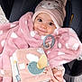 baby, blanket, car_seat, child, clothing, cute, fabric_book, face, hand, hat, infant, indoors, person, pink, polka_dot, portrait, smile, soft_toy, toy, warm