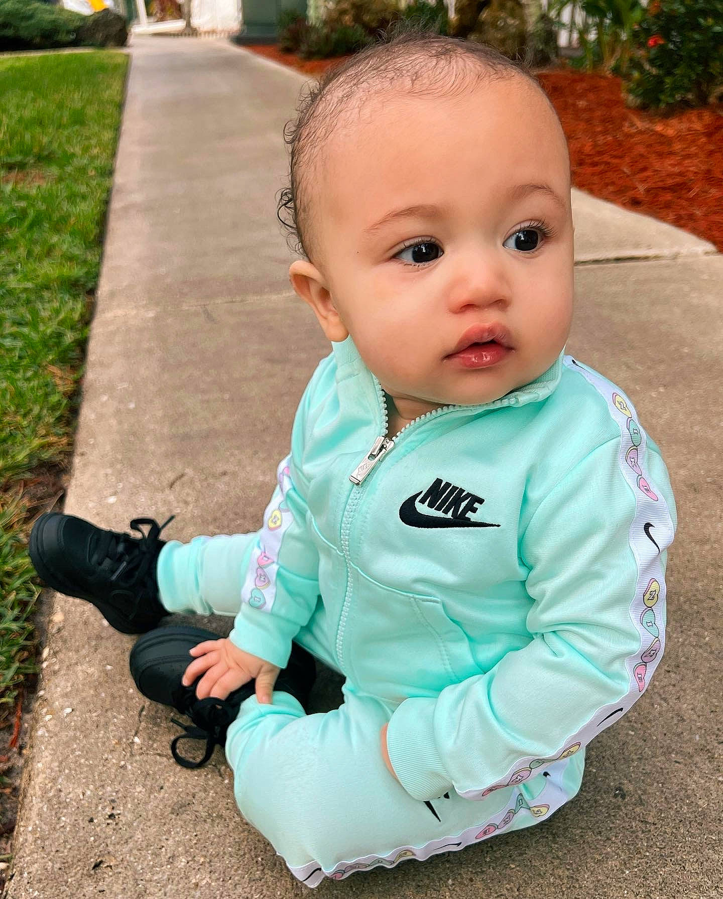 Ariella joined the competition — help win amazing prizes! asphalt, baby, baby_toddler_clothing, cheek, cool, eye, fun, grass, hair, happy, head, iris, nose, person, plant, public_space, road_surface, sitting, skin, sleeve