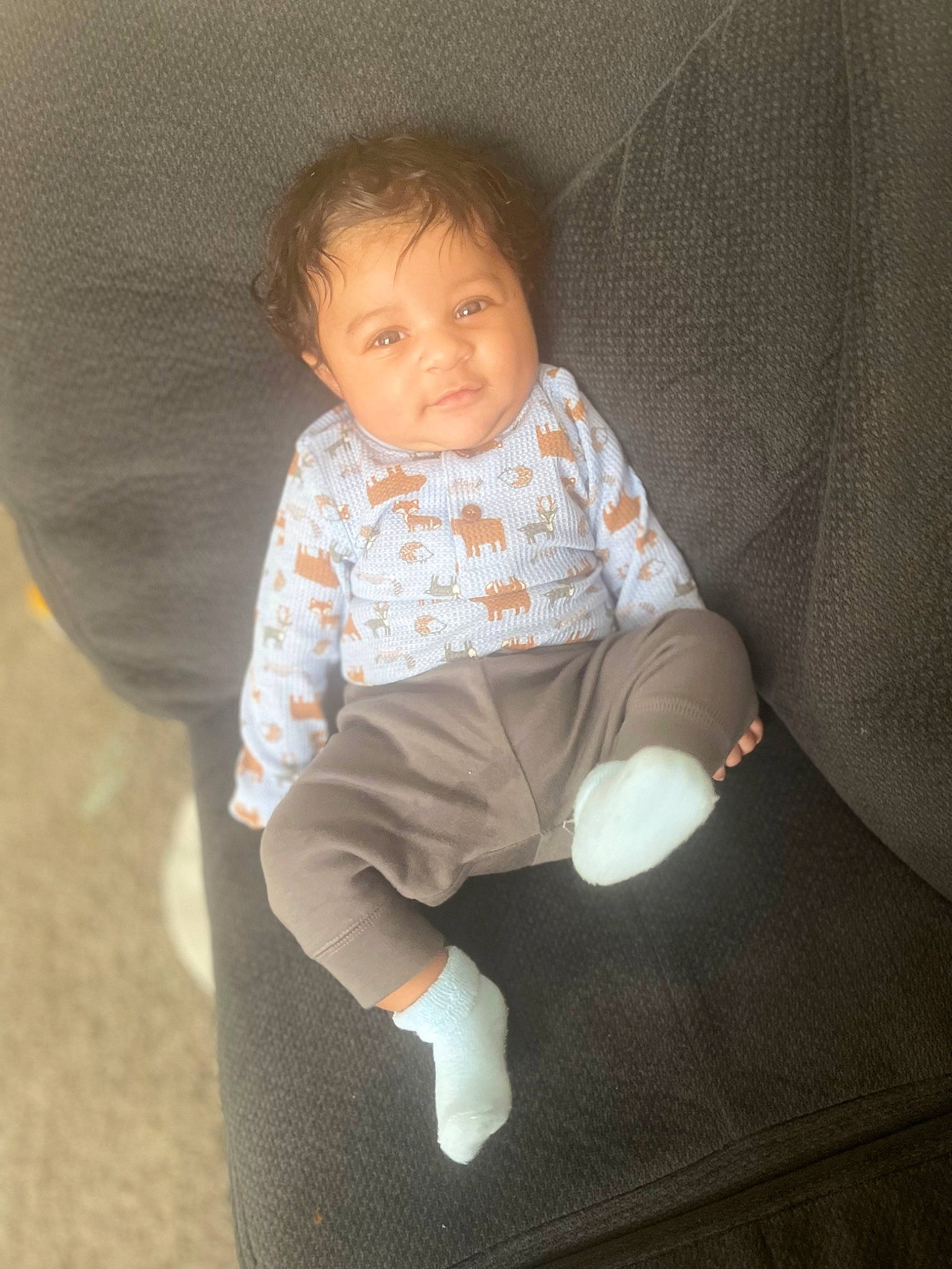Ari Yon is registered to the contest to win money with this photo: baby, baby_products, baby_toddler_clothing, cheek, child, circle, comfort, couch, finger, flooring, human_leg, lap, linens, person, sitting, skin, sleeve, sock, thumb, toddler