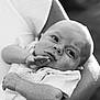 Rowan joined the competition — help win amazing prizes! baby, infant, black_and_white, portrait, close_up, person, child, holding, arm, skin, expression, curious, soft_light, texture, clothing, newborn, face, human, outdoor, gentle