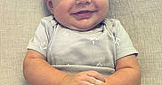 Waylon is registered to the contest to win money with this photo: baby, blue_jeans, child, clothing, couch, cute, eyes, face, hair, hands, happy, indoors, infant, onesie, person, portrait, sitting, skin, smile, young