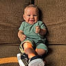 Waylon joined the competition — help win amazing prizes! baby, black_sneakers, casual, child, couch, cute, furniture, green_outfit, happy, home, indoor, infant, person, portrait, relaxed, shadow, sitting, smiling, sunlight, young_child