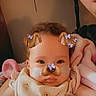 baby, child, face_filter, dog_ears, butterflies, blanket, cozy, indoor, person, infant, cute, portrait, smiling, soft_lighting, closeup, family, parent, childhood, warmth, comfort