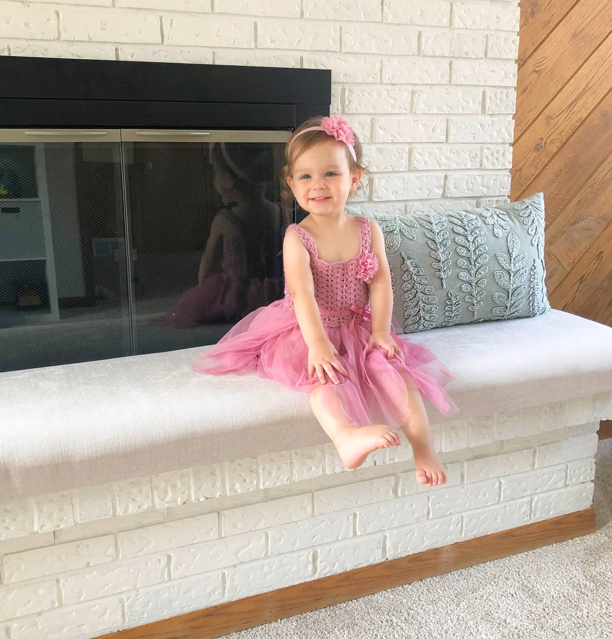 Harlow is registered to the contest to win money with this photo: blond, comfort, couch, day_dress, design, dress, embellishment, floor, flooring, happy, hardwood, joy, magenta, pattern, person, pink, rectangle, sleeve, smile, toddler