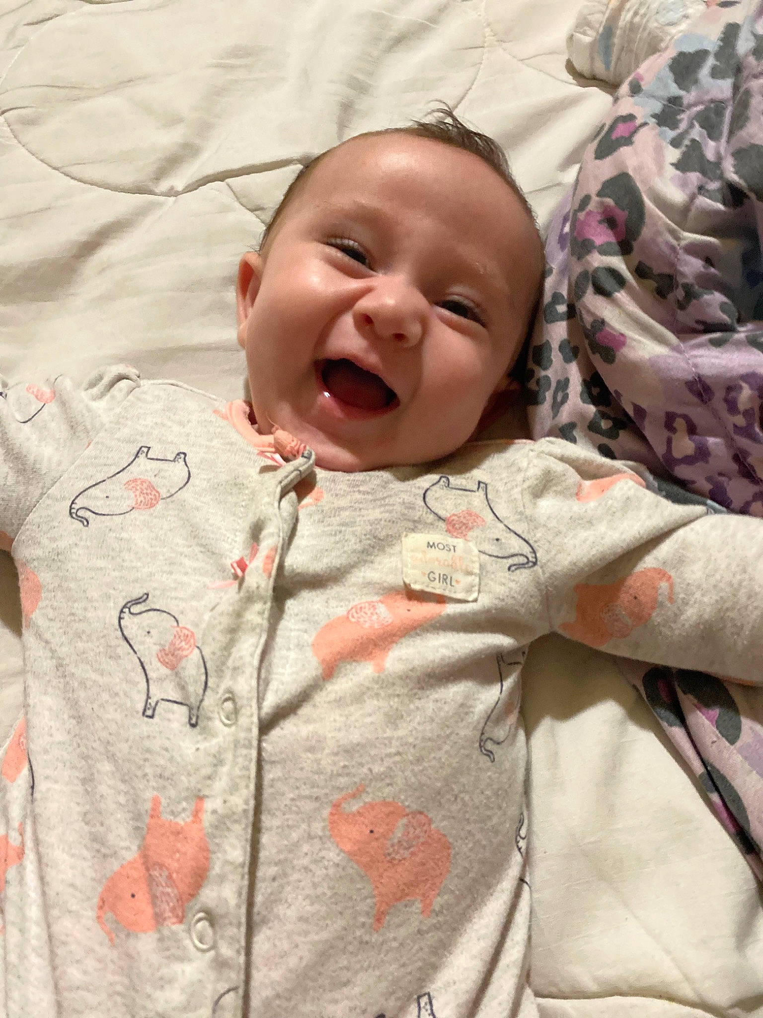 Aleigha is registered to the contest to win money with this photo: baby, baby_toddler_clothing, bedding, bedtime, cheek, child, comfort, eye, grass, happy, linens, mouth, nose, pattern, person, pink, skin, sleeve, smile, textile