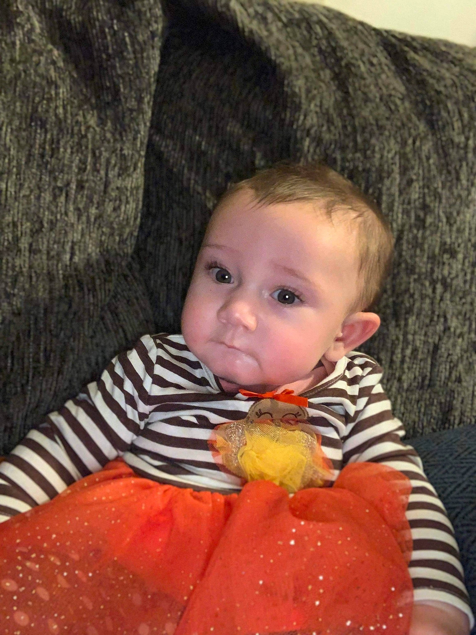 Aleigha is registered to the contest to win money with this photo: baby, baby_toddler_clothing, brown_hair, cheek, child, eye, face, fruit, head, iris, lip, mouth, nose, orange, organ, person, sitting, skin, sweetness, toddler