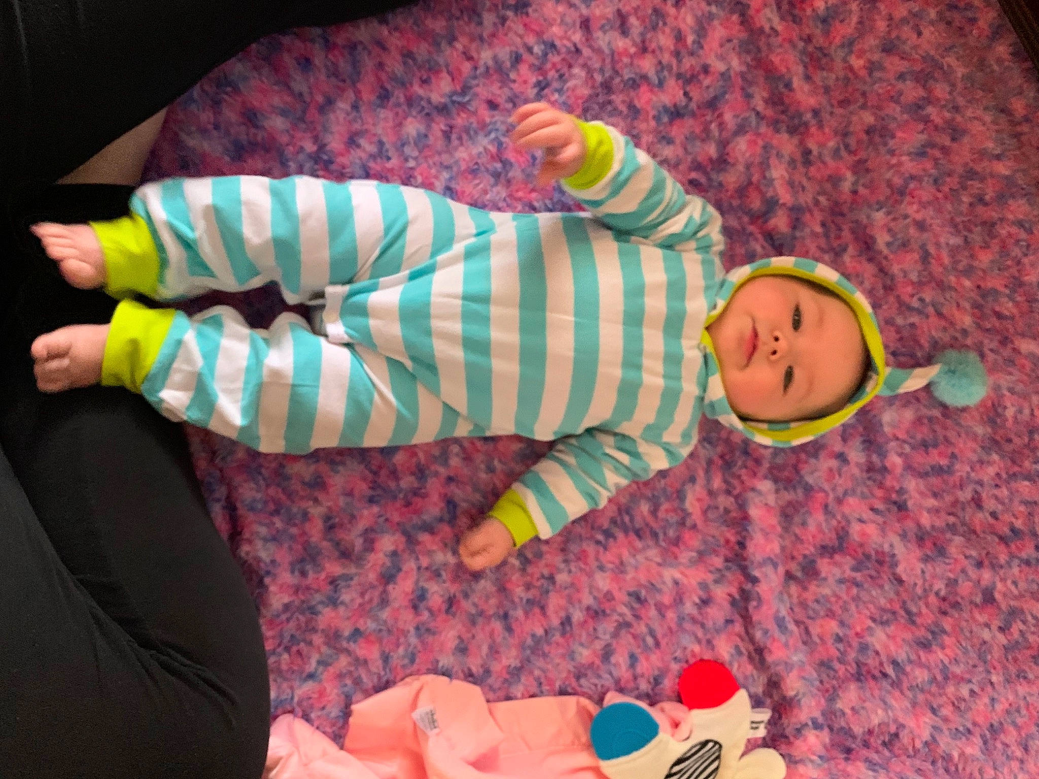 Alessia is registered to the contest to win money with this photo: baby, baby_products, baby_toddler_clothing, child, comfort, facial_expression, finger, fun, hand, headwear, mammal, orange, people, person, pink, product, room, stuffed_toy, textile, toddler