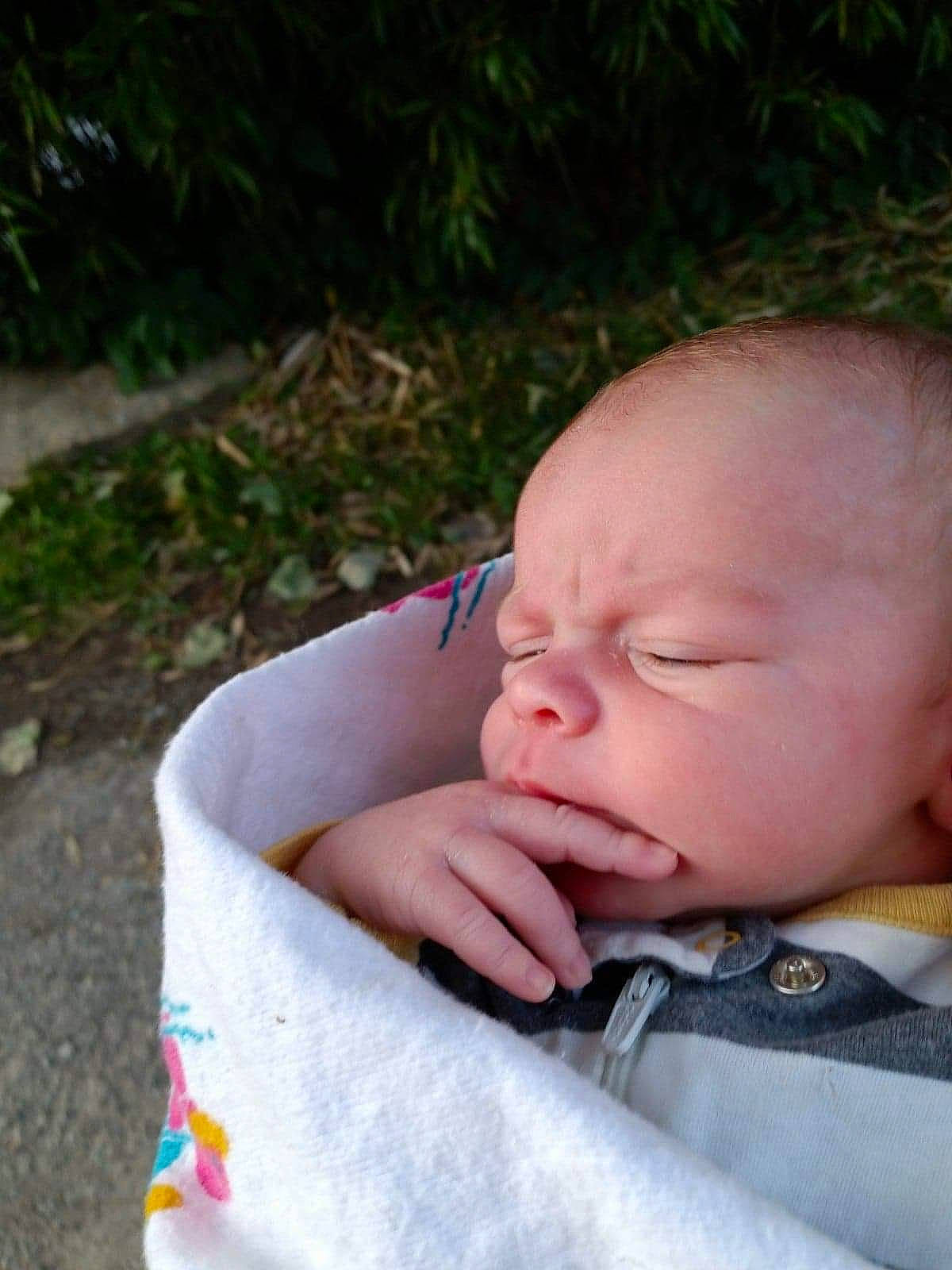 Timothy is registered to the contest to win money with this photo: baby, baby_products, baby_toddler_clothing, cheek, child, comfort, grass, happy, nail, nap, nose, people_in_nature, person, plant, portrait_photography, sitting, skin, sleep, thumb, toddler