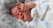 Azariah is registered to the contest to win money with this photo: newborn, baby, infant, sleeping, face, hand, fingers, blanket, fluffy, gray, white, blue, bedding, portrait, studio, cozy, lying_down, peaceful, photography, watermark