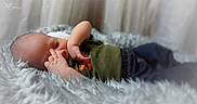 Azariah joined the competition — help win amazing prizes! baby, blanket, clothing, cozy, curtains, face, fingers, fluffy_blanket, green_shirt, hand, indoor, infant, jeans, newborn, peaceful, photography, portrait, sleeping, soft_lighting, studio