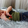 Azariah joined the competition — help win amazing prizes! newborn, baby, infant, sleeping, portrait, face, hand, fingers, blanket, fluffy_blanket, cozy, indoor, studio, curtains, clothing, green_shirt, jeans, soft_lighting, photography, peaceful