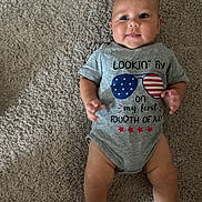 Cameron is registered to the contest to win money with this photo: baby, infant, carpet, onesie, smile, face, child, laying_down, celebration, clothing, cute, happy, person, skin, leg, foot, hand, indoor, photography, portrait
