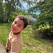 Elijah joined the competition — help win amazing prizes! child, boy, curly_hair, smile, outdoor, grass, trees, sunny, tshirt, nike, playful, nature, house, greenery, daylight, person, portrait, casual, happy, young
