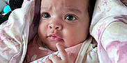 Kinsley is registered to the contest to win money with this photo: baby, infant, blanket, pink, curly_hair, face, hand, expression, indoor, closeup, soft, cute, child, clothing, bib, skin, portrait, newborn, resting, thoughtful